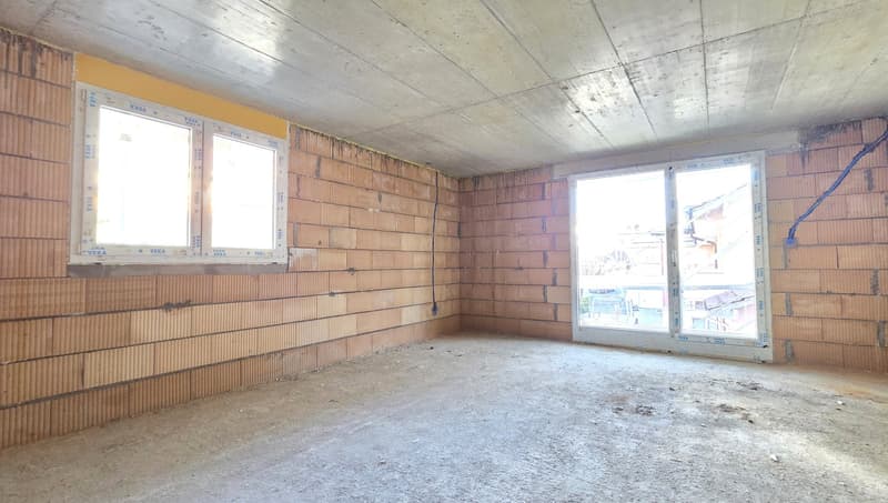empty room, brick walls, two windows, unfinished floor