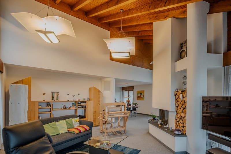 wooden ceiling, fireplace, couch, coffee table, wooden loom, shelves, TV