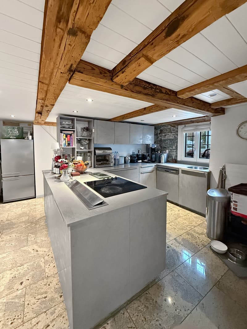 modern kitchen with island, wooden beams, granite floor, stainless steel appliances, dishwasher