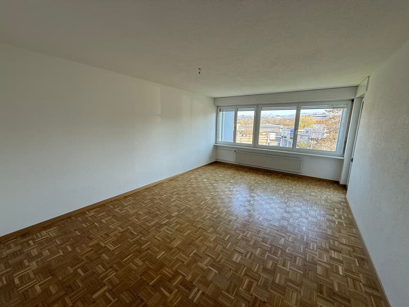 empty room, wooden parquet floor, large window, white walls, radiator