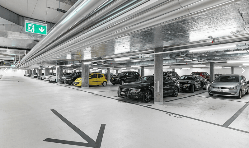 A multi-level parking facility with multiple vehicles parked in the designated parking spots.