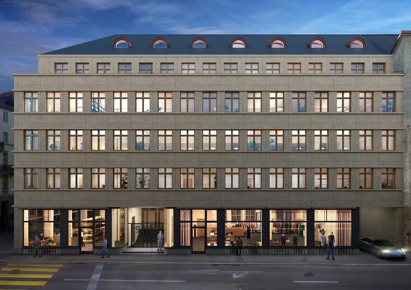 Modern building with multiple windows, arched windows on the top floor, glass doors, and a car parked in front.