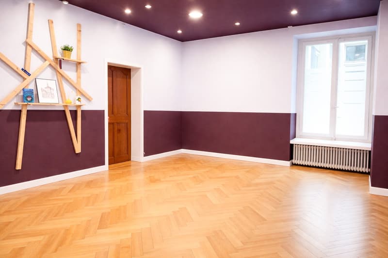 Empty room, wooden floor, wooden door, windows, radiator, wooden shelves