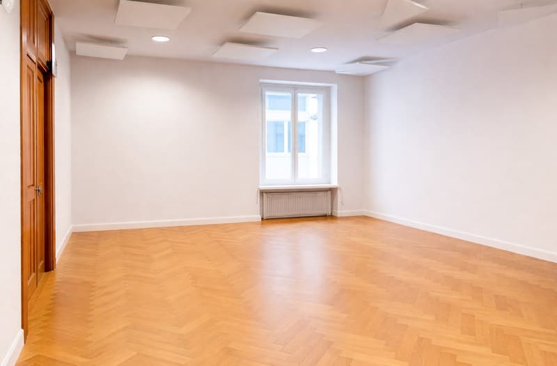 empty room, wooden parquet floor, white walls, radiator, large window