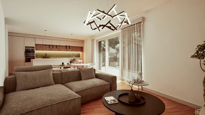 Spacious living room with large windows, modern lighting fixture, wooden cabinetry, and a comfortable gray sofa. The room has an open layout that connects to the kitchen area.