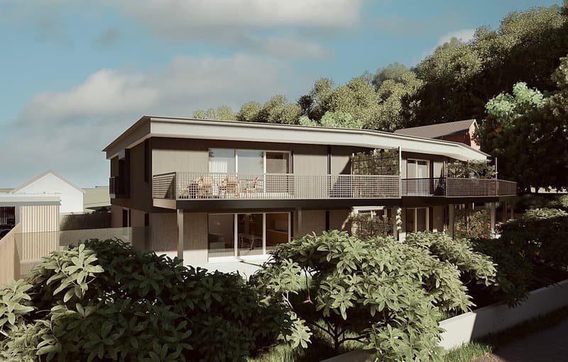 Two-story modern house with a balcony, surrounded by lush greenery and trees