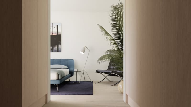 blue bed with white sheets, nightstand with lamp, black chair with white legs, rug, and a potted palm plant.