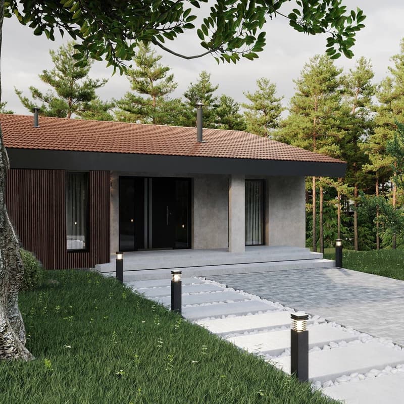 Single-story modern house with a tiled roof, dark wooden siding, and large windows. The house is surrounded by a grassy lawn and pine trees. There is a paved walkway leading to the entrance and outdoor lighting fixtures along the path.