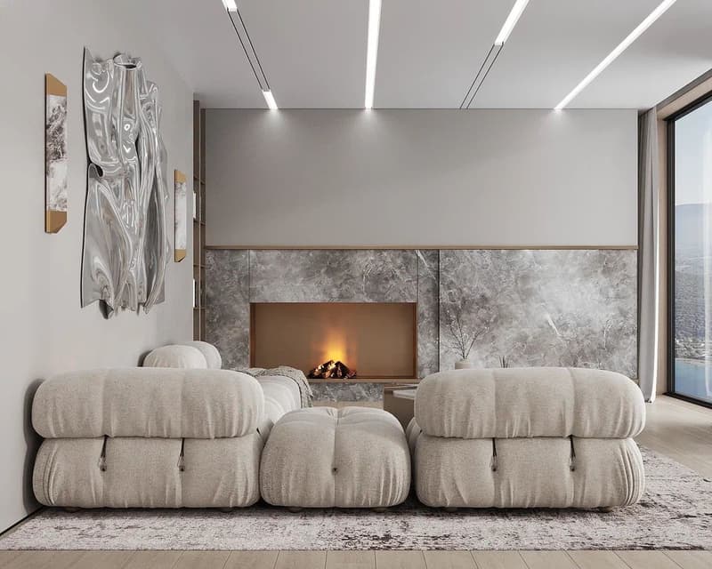 modern living room with white furniture, fireplace, marble wall, gray rug, ceiling lights