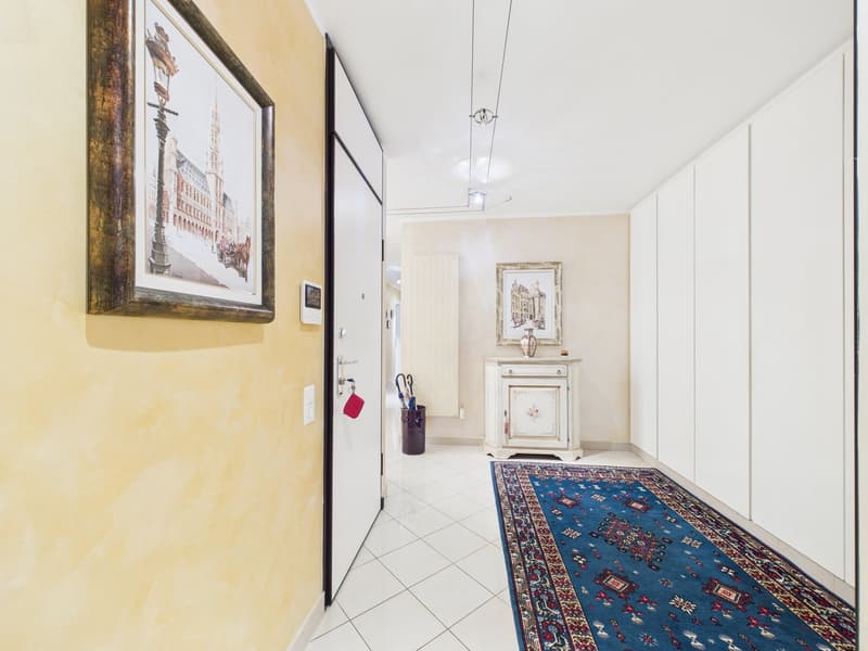 tiled floor, yellow wall, white door, picture frame, rug, cabinet, umbrella stand, radiator