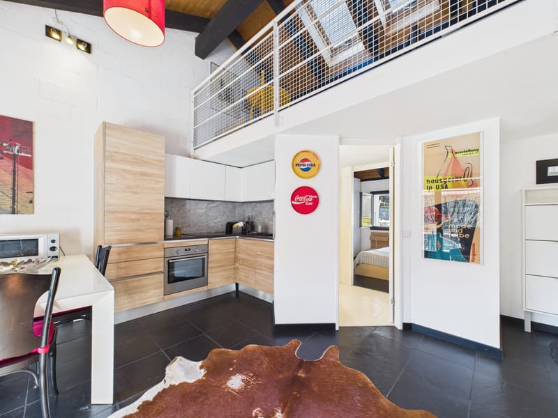 modern kitchen, dining area, open living room, balcony, white walls, black tiles, wooden cabinets, stainless steel appliances, decorative posters