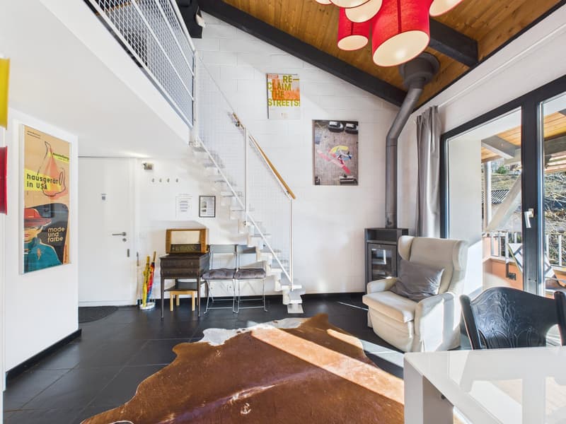 modern interior, white walls, black tiled floor, white armchair, brown rug, staircase, glass door, posters on the wall