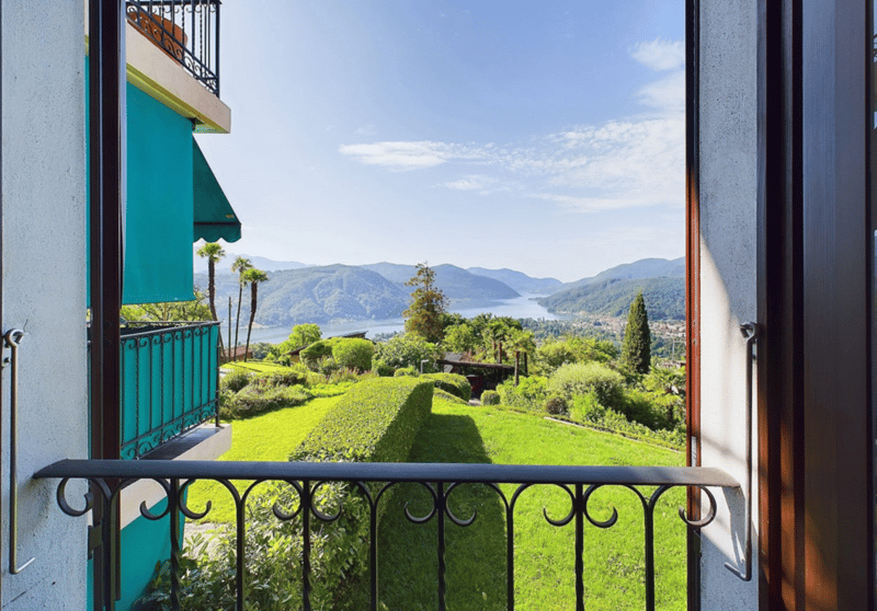 balcony with railings, view of a lake and mountains