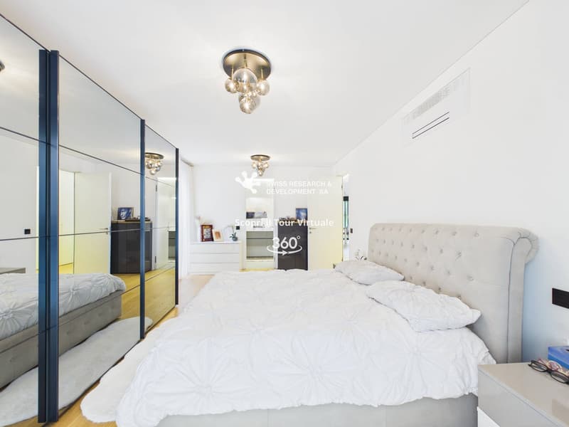 modern bedroom with white bedding, large mirror, wooden floor, ceiling lamps, nightstand