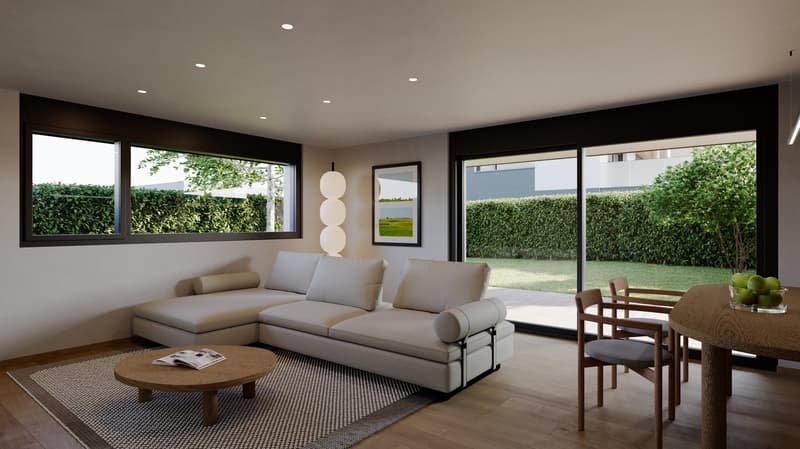 Spacious living room with large windows overlooking a garden, modern gray sectional sofa, round wooden coffee table, and a dining area with a wooden table and chairs.