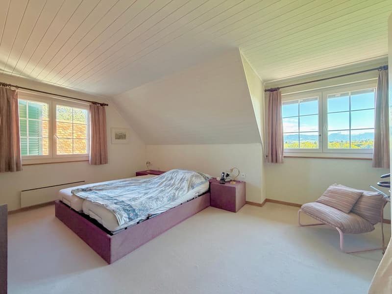 pink double bed, bedside tables, picture frame, window, pink chair