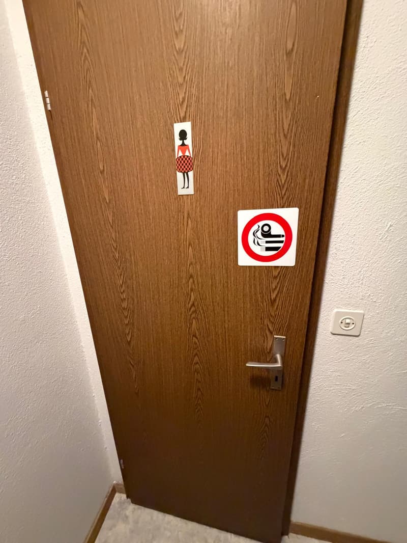 wooden door, white wall, no smoking sign, woman sign