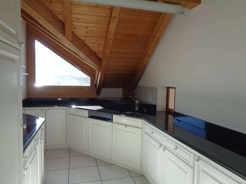 kitchen with an island, white cabinets, black granite countertops, tiled floor, wooden ceiling