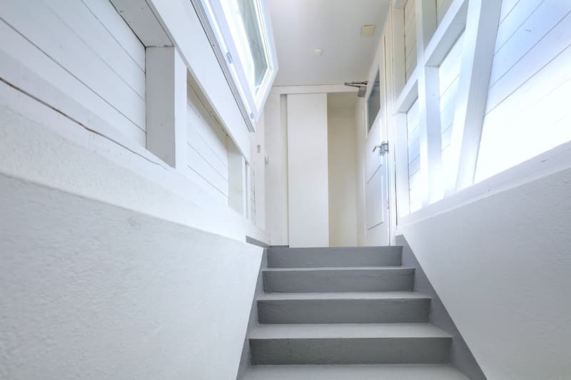 clean white walls, concrete stairs, skylight window, wooden planks