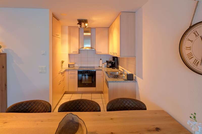 kitchen with oven, sink, refrigerator, cabinets, open ceiling light, table and chairs