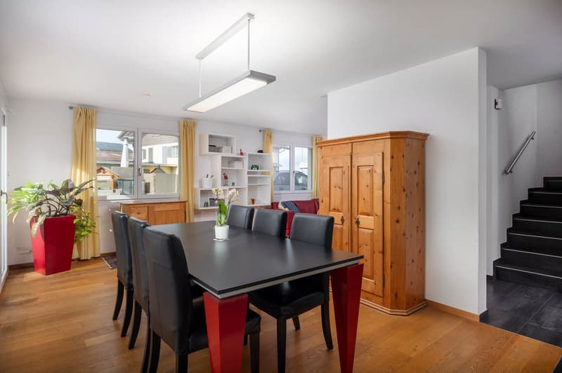 Dining table with 6 chairs, wooden floors, large windows, wooden cupboard