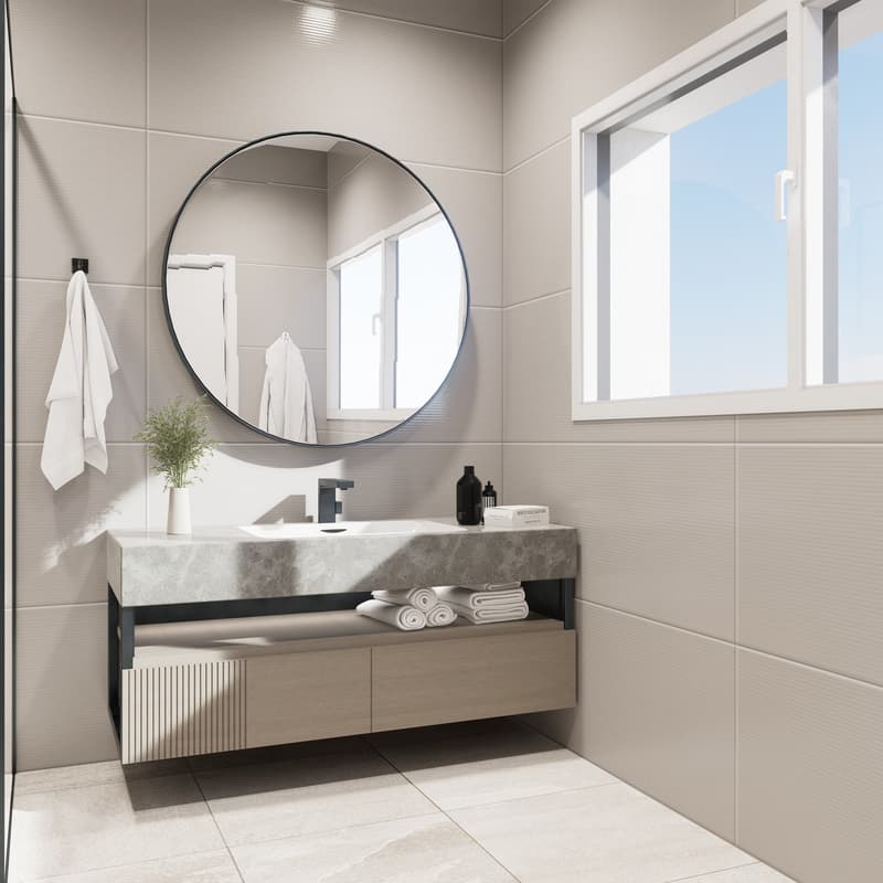 Modern bathroom with a large round mirror, a marble vanity with drawers, and a window providing natural light. The bathroom is tiled with neutral-colored tiles and has towels and a potted plant for decor.