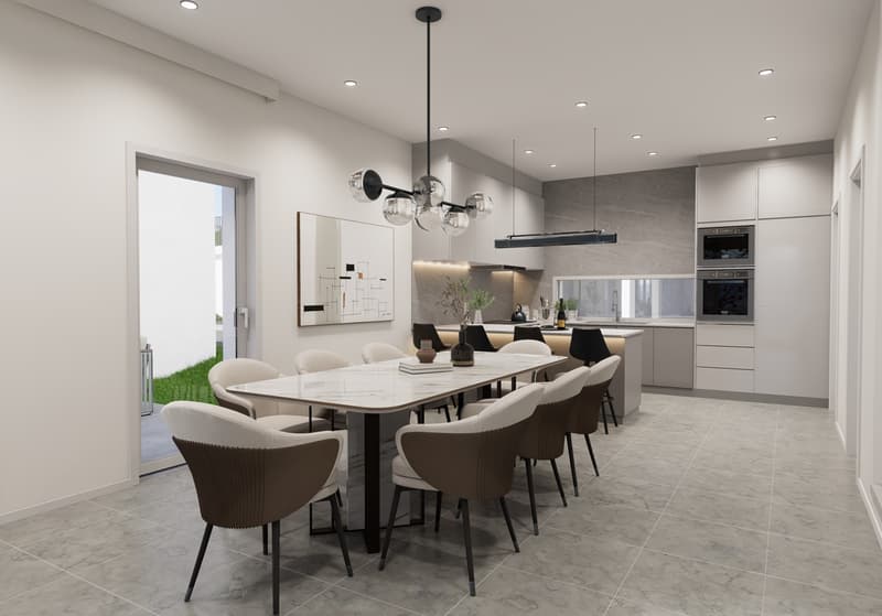 The image shows a modern and open-concept kitchen and dining room. The kitchen features sleek gray cabinets, a built-in oven, and a dishwasher. The dining area has a large rectangular table with comfortable upholstered chairs. The room is well-lit with a