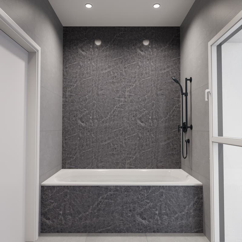 Large gray marble-like tiles covering the walls and floor, a built-in bathtub, and a black shower fixture on the wall.