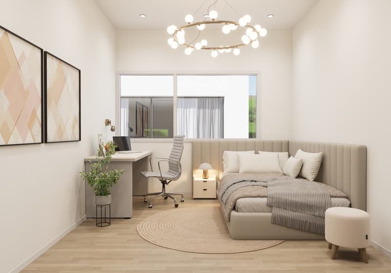 Spacious bedroom with large windows, plush beige upholstered bed, desk with chair, circular rug, and modern chandelier lighting.