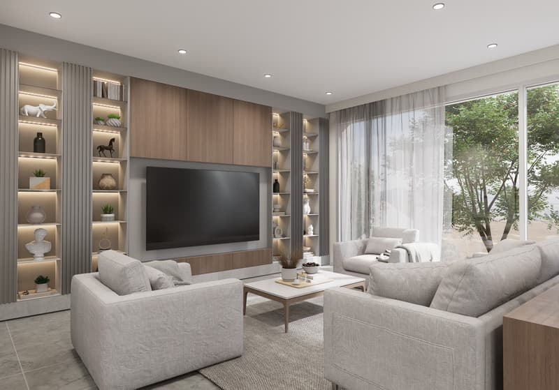 Spacious living room with large windows providing a view, gray and wood-toned color scheme, built-in shelving units flanking the TV, plush gray sofas, and a coffee table.