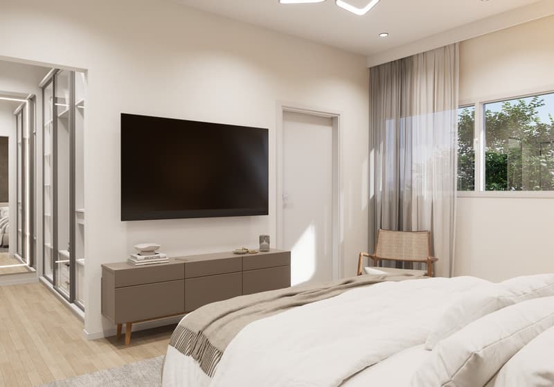 Spacious bedroom with large windows, hardwood floors, a TV mounted on the wall, a dresser, and a comfortable chair.