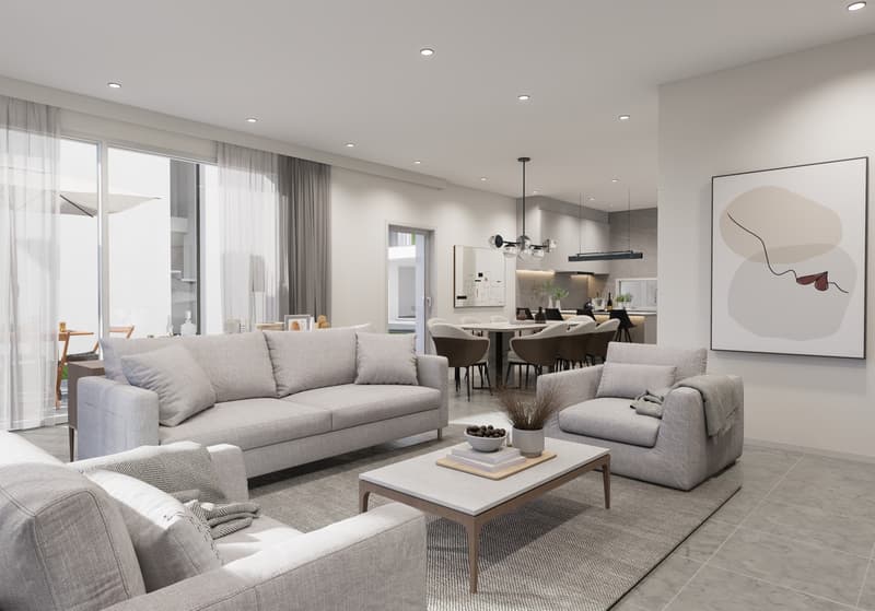 Spacious open-concept living room and dining area, with large windows, grey sofas, coffee table, and modern artwork on the wall. The kitchen is visible in the background, with a dining table and chairs. The space has a clean, minimalist design with neutra