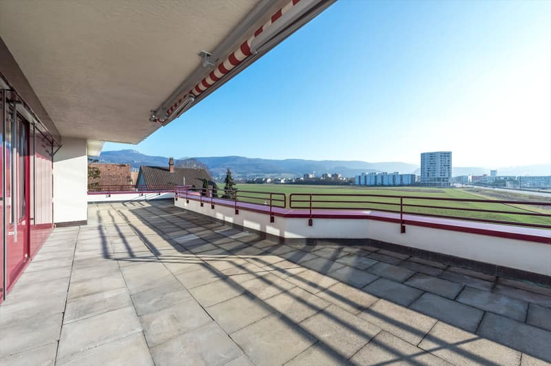 tiled floor, metal railings, fenced area, panoramic view, distant city landscape