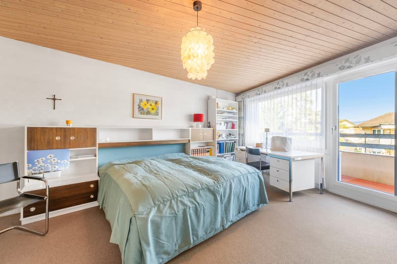 Queen-sized bed, night stands, cabinet, desk, chair, white walls, picture, cross
