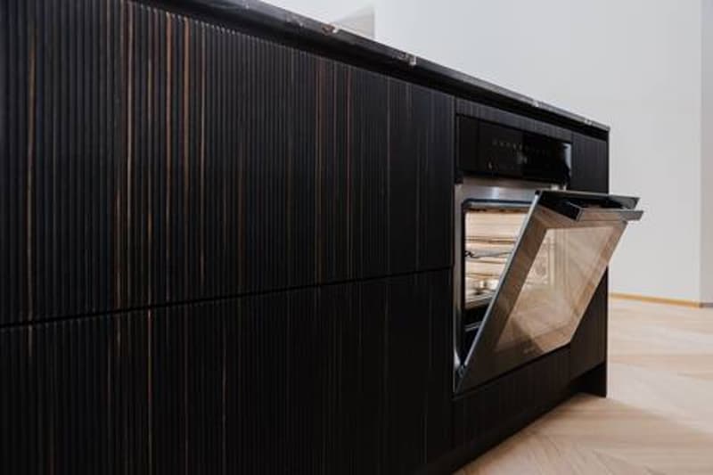 Black wooden kitchen cabinets, built-in dishwasher