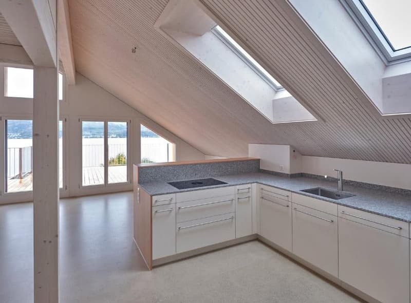 attic room with glass doors leading to balcony, two skylights, granite countertop, modern kitchen