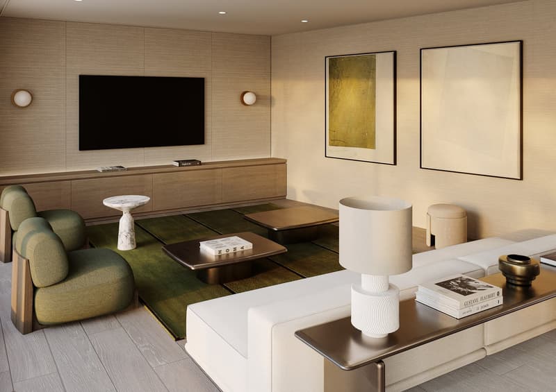 Living room with contemporary furniture, green rug, flat screen TV, side tables, sofa, armchairs, light fixtures, artwork