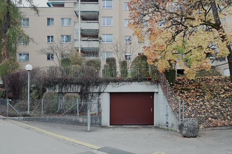 An exterior of an apartment building with an underground garage.