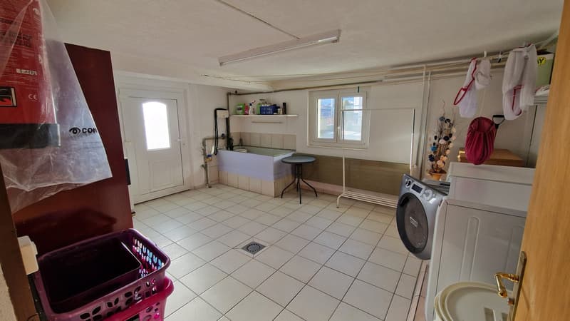 Washing machine, Dryer, Storage baskets, tiled floor, washing area, drying area