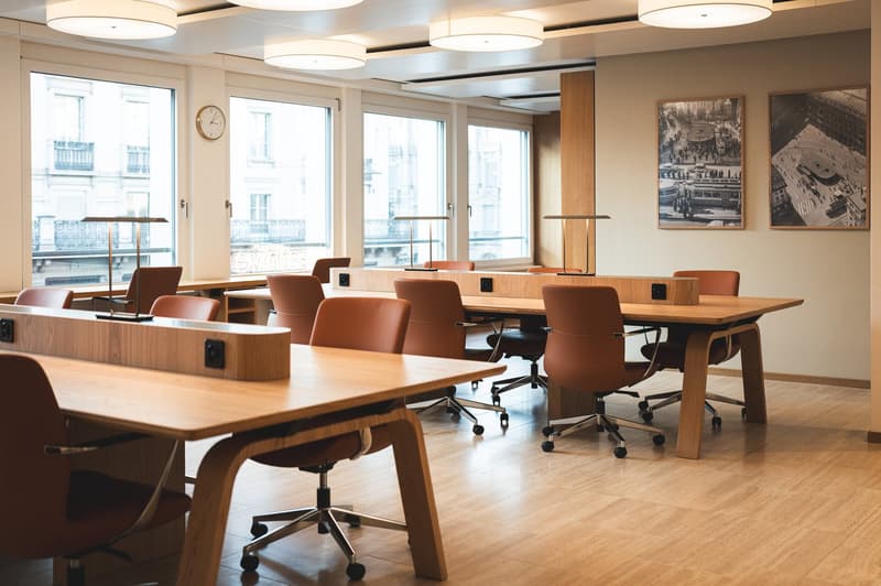 modern office meeting room, long wooden desk, leather chairs, floor-to-ceiling windows, lamps