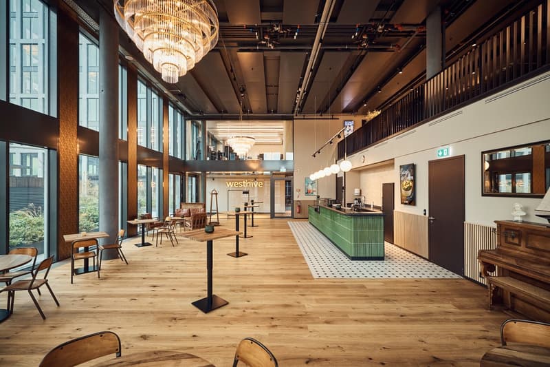modern design, wooden floor, chandeliers, large windows, reception desk, various seating arrangements