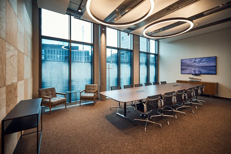 modern office room with large windows, conference table, and chairs