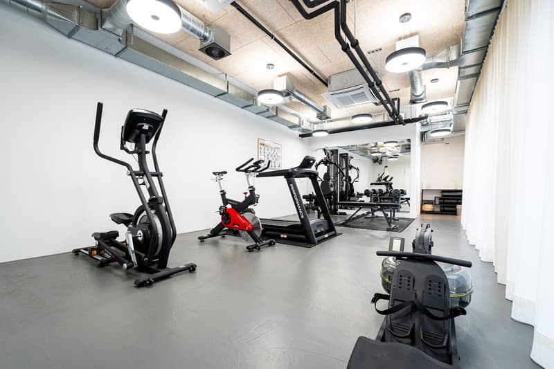 modern gym with various exercise machines and free weights.