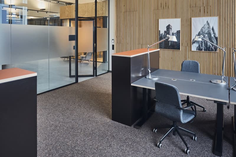 open space with tables, chairs, lamps, framed wall art, sliding glass wall, floor lamp, gray carpet