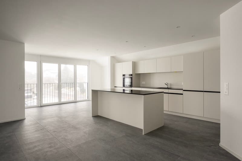 Open kitchen, balcony, sliding glass doors, gray tiled floor, white kitchen cabinets, black island countertop, modern appliances, minimalistic design