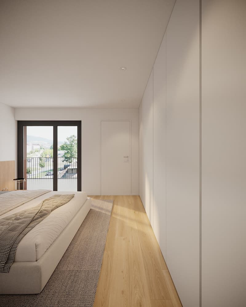 spacious bedroom with large window, balcony, wooden floor, and white walls