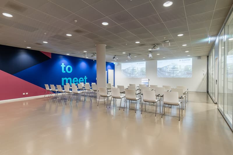 modern designed meeting room, multiple white chairs, 2 projectors