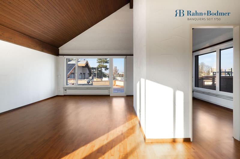empty room with hardwood floor, large windows, wooden ceiling, balcony