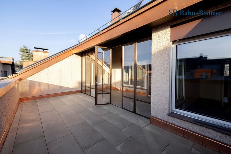 Roof terrace with tile flooring, sliding glass doors, metal railings, and large windows