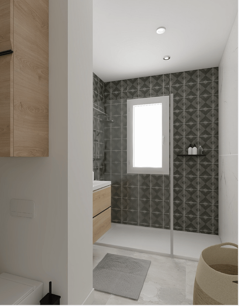 a small bathroom with a glass shower, white sink, wooden cabinet, and tiled wall